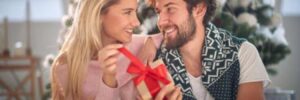 A man gives a woman a Christmas gift